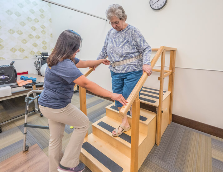 woman using stairs in rehab